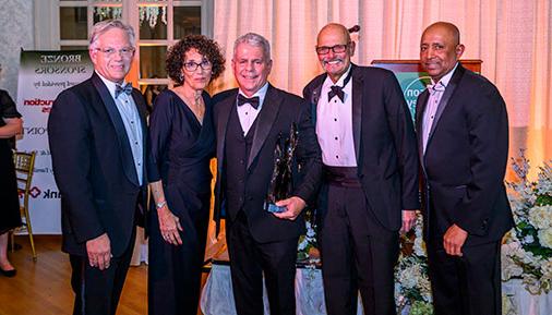 Don Fane and others pose with award